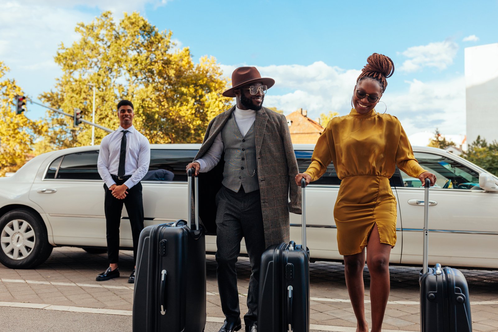 Wealthy couple leaving limousine.