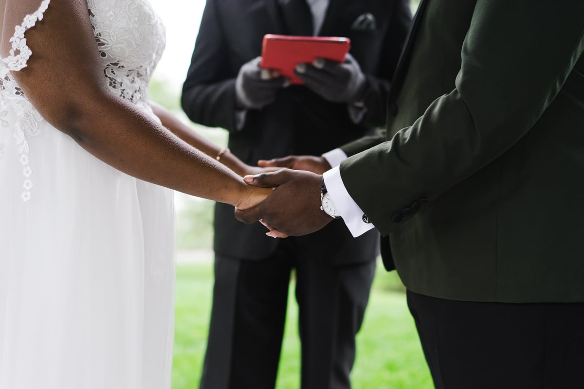 Bride and Groom Holding Hands at a Wedding 